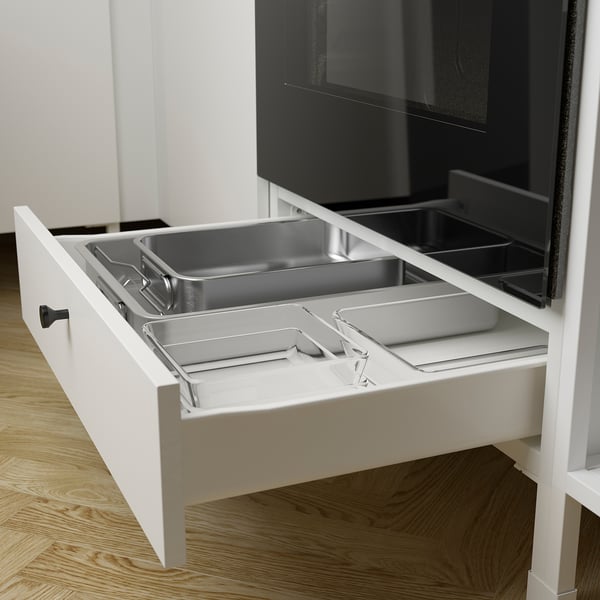 Kitchen drawer with oven, organized compartments for tools.