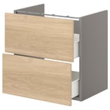 This image shows an ENHET bathroom cabinet in oak with two drawers. The cabinet is wooden with grey sides and open drawers revealing inner organizers.
