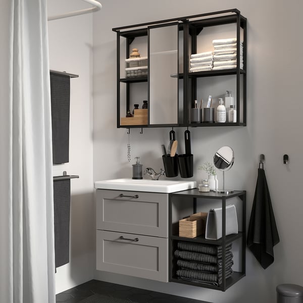 Modern grey bathroom with ENHET vanity, mirror, and shower.
