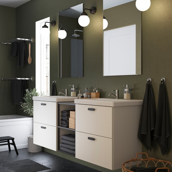 Elegant bathroom with a double off-white ENHET vanity, spacious and modern, contrasting green walls.