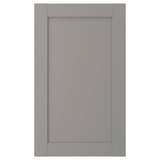 A grey ENHET cabinet door made of fiberboard with a foil finish. It has a sleek, rectangular shape with a simple, flat design.