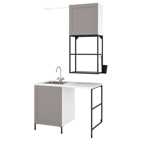 Modern laundry setup with grey cabinets, sink, and metal frame. Clean, organized design for small spaces.