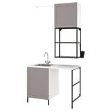 Modern laundry setup with grey cabinets, sink, and metal frame. Clean, organized design for small spaces.