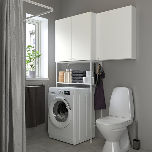 Small, white ENHET storage unit fits under cabinets, holding laundry essentials neatly. Perfect for compact spaces.