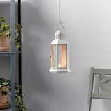 Hanging lantern with warm glow, illuminated by tealight, suitable for indoor/outdoor use.