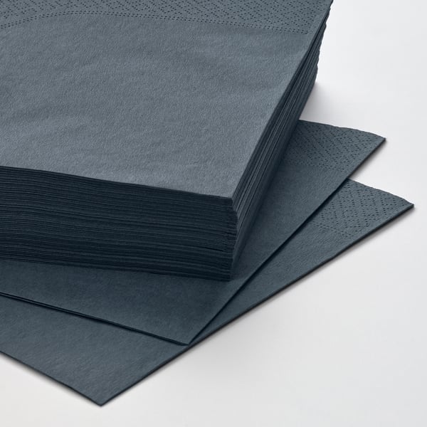 Stacked dark blue FANTASTISK napkins, neatly arranged in a pile, showcasing their soft texture and smooth edges.