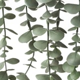 Artificial eucalyptus plant with vibrant green leaves, arranged naturally for lifelike appearance.