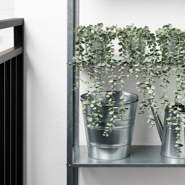 Metal shelf with two artificial plants in galvanized pots, suitable for indoor/outdoor use.