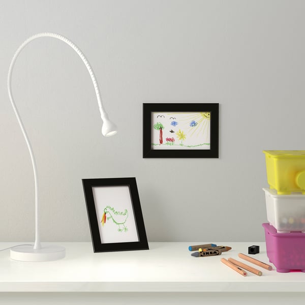 Desk with lamp, drawings, pencils - creative workspace.