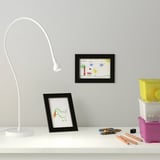 Desk with lamp, drawings, pencils - creative workspace.