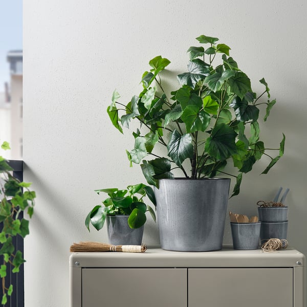 FJÄRILSBUSKE plant pots: grey, stoneware, varied sizes, simple & rustic, displayed outdoors with plants.