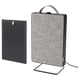 A black FÖRNUFTIG air purifier with a fabric front and a removable handle for portability. It stands on a metal stand.
