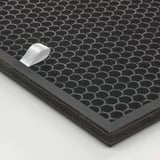 Black honeycomb-patterned charcoal filter for gas cleaning, bordered by durable black plastic, laid on a white surface.