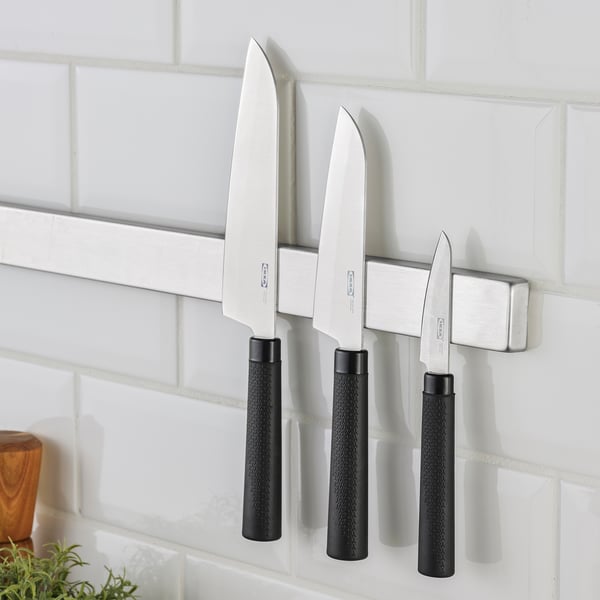 Four knives: two large, one small, parer. Black handles.