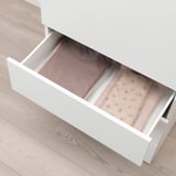 Ritten drawer displaying folded clothes, part of ikeas platsa storage series.