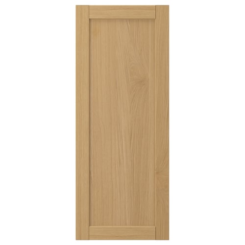 A FORSBACKA wooden door in light brown with a framed design. It oak veneer and a classic bevelled edge style.