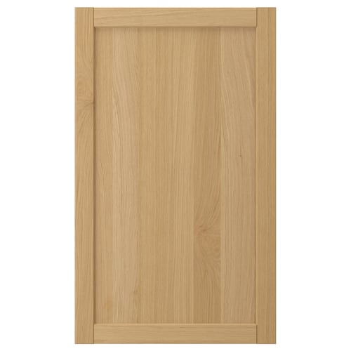 Natural wood cabinet door with bevelled edges.