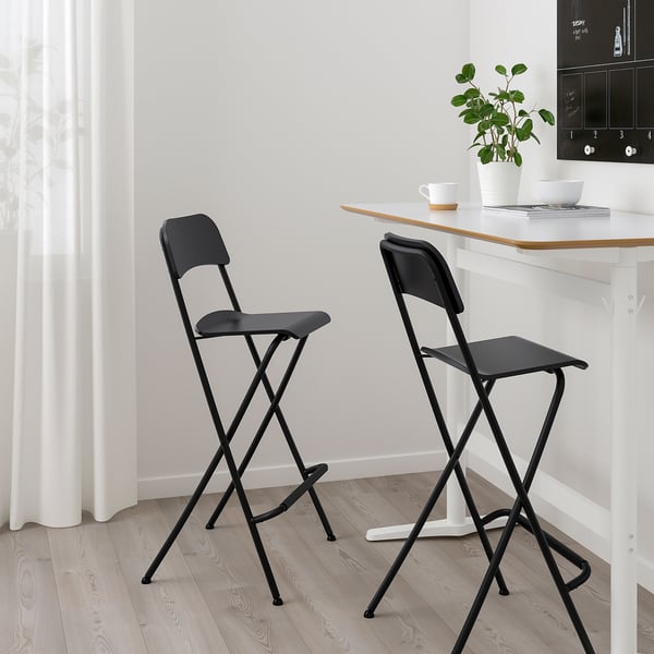 Black FRANKLIN bar stools; simple, foldable, sturdy. Perfect for small spaces; fits well under counters.
