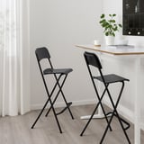 Black FRANKLIN bar stools; simple, foldable, sturdy. Perfect for small spaces; fits well under counters.