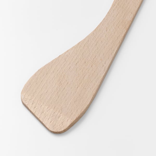 A smooth, light-colored wooden spatula lies on a plain background, showcasing its clean, polished surface and sturdy craftsmanship.