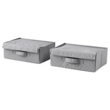 Two light gray fabric storage boxes with handles, rectangular and lid-covered, likely for organizing items.