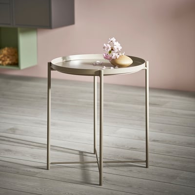 Round GLADOM tray table in beige. Light, modern design with removable tray and metal legs.