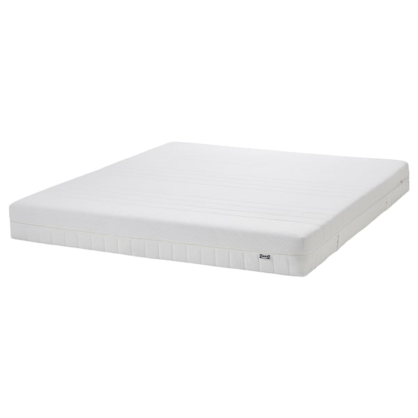 White IKEA GLAMBERGET extendable bed with foam mattress. Solid pine frame, space-saving, fits small rooms.