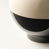 Modern vase with sleek contrast: beige matte top, glossy black bottom. Elegant design for contemporary spaces.