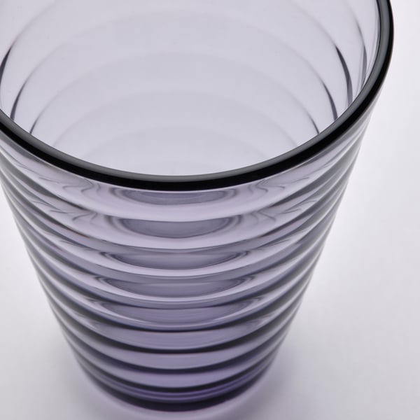Clear glass tumbler with wavy, spiral design, durable and sleek.
