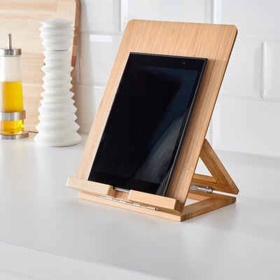 Tablet holder with adjustable angle, made of bamboo, on kitchen counter.