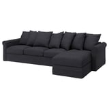 Dark grey, deep seat, l-shaped sofa with soft cushions.