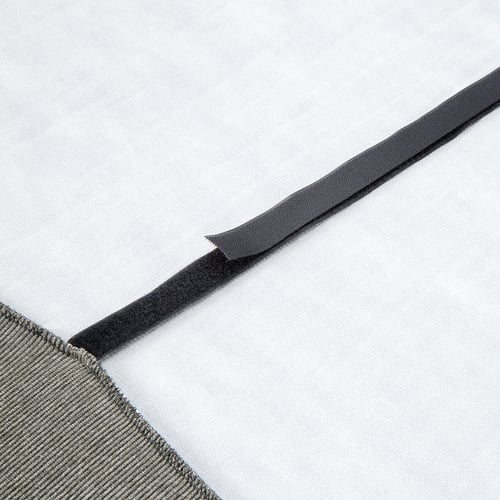 Close-up of a neatly folded grey elastic strap from a high-quality fitted sheet, focused on its durable, textured finish.