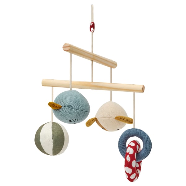A colorful knitted baby mobile with whale, bear, and fish toys.