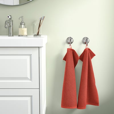Bathroom: white vanity, chrome, two red GULVIAL towels on hooks.