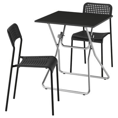 Black GUNDE foldable table and chairs set, sleek modern design, durable steel and plastic.