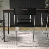 Foldable chair, metallic legs, black seat & back. Carry handle, up to 100 kg.