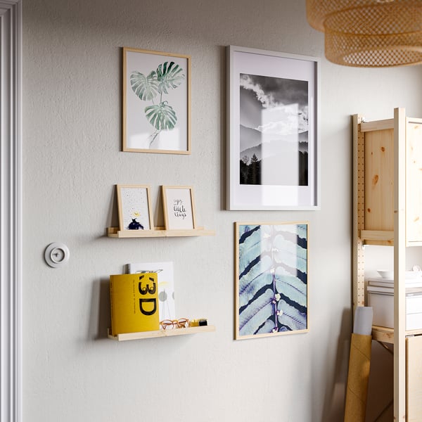 Framed tropical leaf, landscape, quotes on pine shelf.