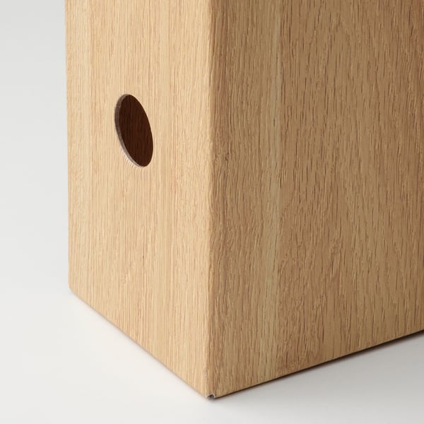 A sleek wooden box with smooth grain texture and a neat circular cutout, showcasing fine craftsmanship.