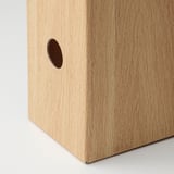 A sleek wooden box with smooth grain texture and a neat circular cutout, showcasing fine craftsmanship.