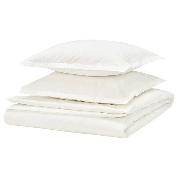 Clean, white bedding set with folded duvet and pillows, crisp cotton percale, classic style.