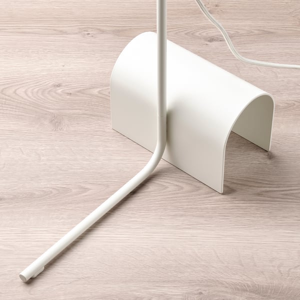 Modern white floor lamp with adjustable neck and base, on wooden floor.