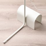 Modern white floor lamp with adjustable neck and base, on wooden floor.