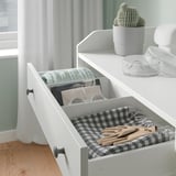 HAUGA dresser with 3 drawers, scarves, gloves, accessories. Plaid liner, gray drapes, cactus.