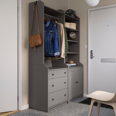Modern entryway setup with gray HAUGA wardrobes, hanging jackets, and bags.