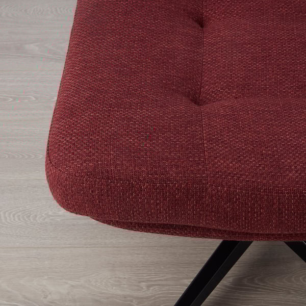 Close-up of red-brown fabric on upholstered furniture, showcasing texture and quality.