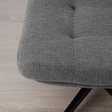 Close-up of grey footstool on wooden floor. Upholstery texture and metal legs. Comfortable, durable design.