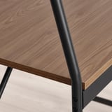 Close-up of HÅVERUD table: smooth, dark wooden top & sturdy black metal leg, craftsmanship detail.