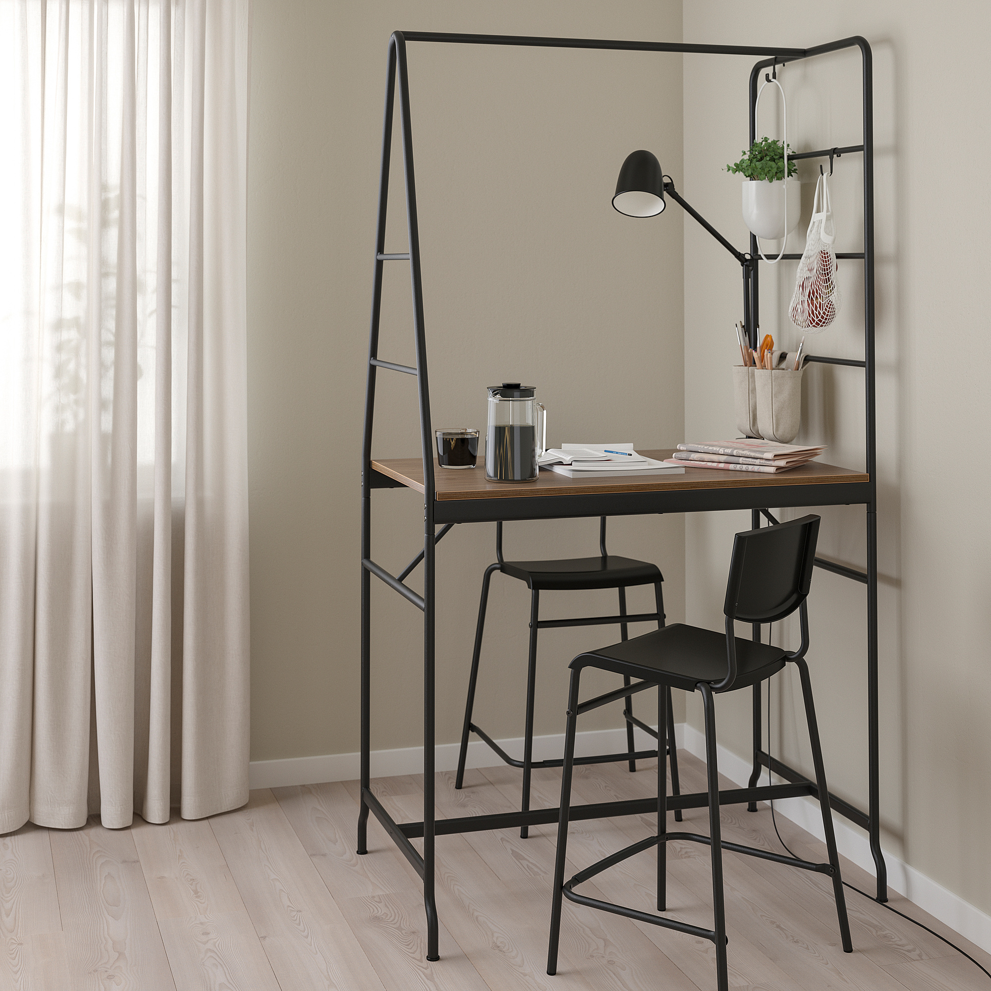 Black HÅVERUD counter table with stools, storage ladder, and lamp.