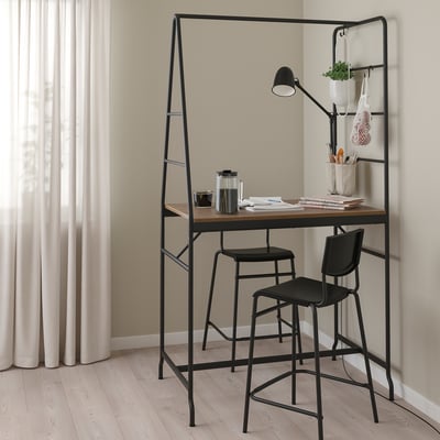 Black HÅVERUD counter table with stools, storage ladder, and lamp.