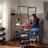 Woman sewing at HÅVERUD table with storage.